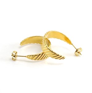Detailed close-up of 18K gold plated titanium earrings with textured ribbed design