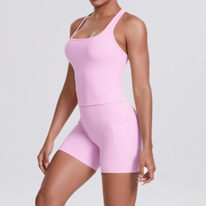 Detail of pink sports bra and high-waisted shorts with side pocket for workout