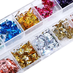 Detailed top view of 12-color nail art foil flakes in a transparent storage box for DIY