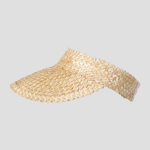 Detailed view of hand-woven wheat straw texture and jagged edge on a sun visor hat