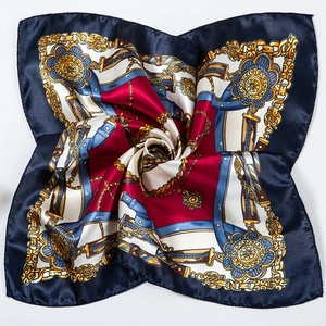 Detailed close-up showing the chain pattern and silky texture of the navy blue square scarf