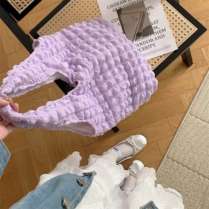 Detail of purple bubble textured shoulder bag with 3D cloud pleated pattern design