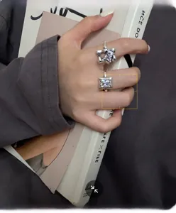 Detail of 925 sterling silver rings with star and square zirconias on model's hand