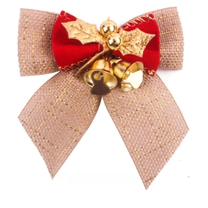 Detail of burlap and velvet Christmas bow with gold leaves and small twin bells