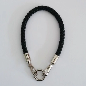 Detail of black braided leather wrist strap with silver metal spring ring and buckle