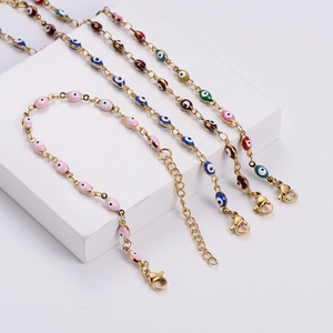 Close-up of Turkish evil eye bracelets with gold chains and colorful enamel beads