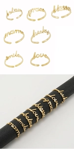 Detail view of 18K gold plated stainless steel adjustable rings with scripted text motifs