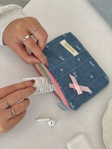 Blue denim coin purse with embroidered bows and pink ribbon for storing small items