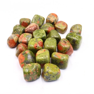 Close-up of polished natural unakite tumbled stones with green and red textures