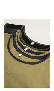 Detail view of water-resistant apron with built-in neck strap hook for easy storage