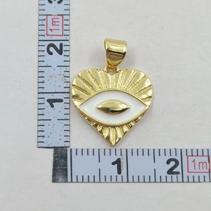 Detailed view of a gold heart pendant with white eye enamel and 2cm measurement