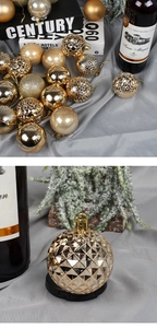 Detailed view of champagne gold Christmas balls with matte and glitter textured finishes