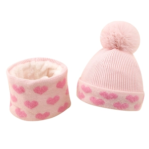 Pink winter knit hat and scarf set for girls featuring jacquard hearts and soft pom-poms