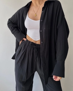 Detail of black crepe long sleeve shirt and matching pants with white ribbed crop top vest