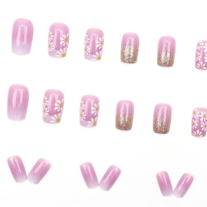 Pink and purple gradient press-on nails with white daisy floral and glitter designs