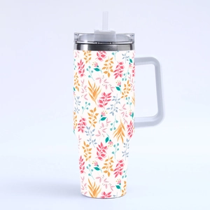 Close-up of 40oz stainless steel tumbler featuring pink and blue floral leaf patterns