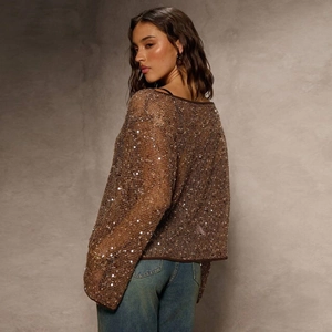 Detail of a brown sequin mesh sweater featuring a trendy hollow-out back design