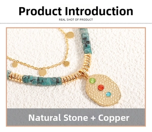 Macro shot of ethnic layered necklace with turquoise stones and textured gold pendant