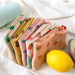 Women's cotton crew socks with colorful fruit patterns on a tray with fresh lemon decor