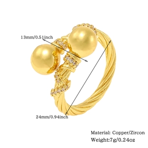 Detail shot of open gold ring with zircon pavé twisted band and dual spherical beads