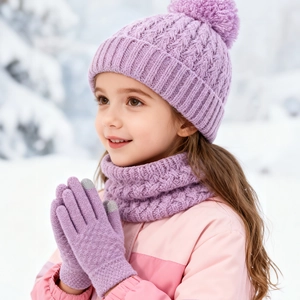 Close-up of purple knit hat with pompom, scarf and touchscreen gloves in the snow