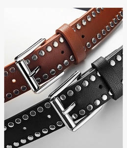 Close-up of punk style black and brown PU belts with silver studs and pin buckles