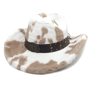Detail of cow print western cowboy hat with vintage bull skull buckle and studded belt