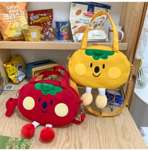 Detail of red and yellow cartoon plush crossbody bags with 3D legs and cute embroidery