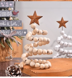 Detail of spiral wooden bead Christmas tree with metal star topper in festive setting