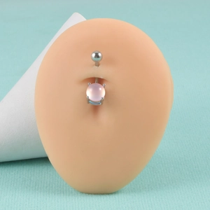 Detailed view of a silver stainless steel belly ring with a pink round gemstone on a model