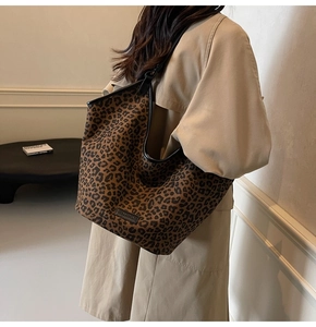 Fashion leopard print tote bag styled with a beige trench coat for a trendy autumn look