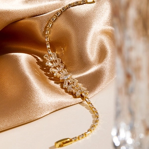 Macro view of gold luxury bracelet with baguette-cut and marquise-cut cubic zirconia stones