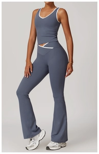 Detail of cross high-waisted flared yoga pants with contrast piping and soft stretch fabric