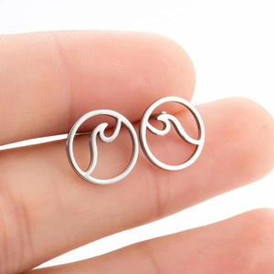 Minimalist silver wavy circle stud earrings in stainless steel shown for size on fingers