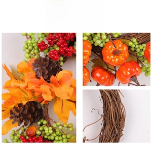 Close-up of autumn wreath with orange pumpkins, maple leaves and berries on rattan base