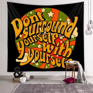 Close-up of Bohemian tapestry with vintage typography on a white brick wall background