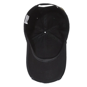 Inside view of black cotton baseball cap showing 100% cotton label and metal buckle