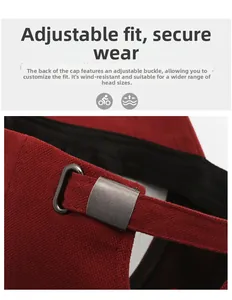 Detail of red baseball cap featuring twill fabric and vintage metal adjustment buckle