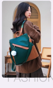 Fashionable dark green anti-theft backpack for women with white pompom charm detail