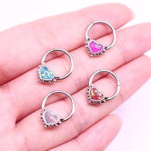 Close-up of four heart-shaped opal nose rings in pink blue red and purple finishes