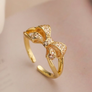 Elegant gold plated bow ring with white zircons featuring an adjustable open design