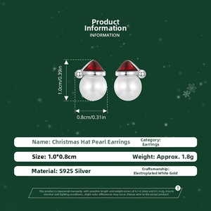 Detail view of S925 silver Christmas hat pearl earrings with red cubic zirconia