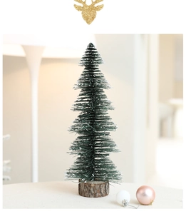 Detail of mini Christmas tree with snow effect on needles and natural wooden base