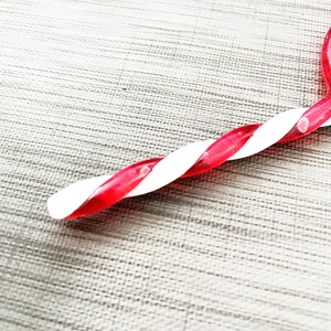 Macro view of spiral red and white candy cane ornaments for Christmas tree decoration