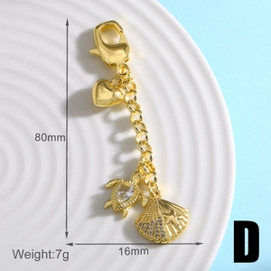 Detailansicht der 18k Gold Seestern Schlüsselanhänger mit Herz, Schildkröte und Muschel