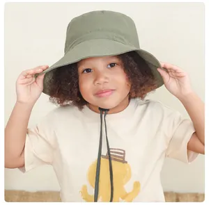 Detail of army green kids bucket hat with adjustable chin strap and wide sun protective brim