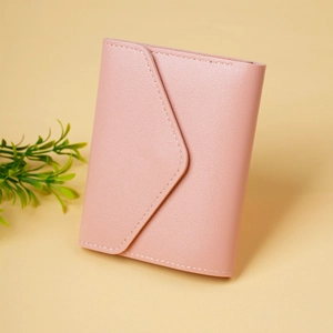 Detail of pink faux leather envelope wallet showing fine stitching and grain texture
