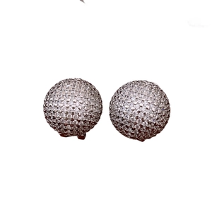 Minimalist silver needle stud earrings with round pavé-set cubic zirconia on white background