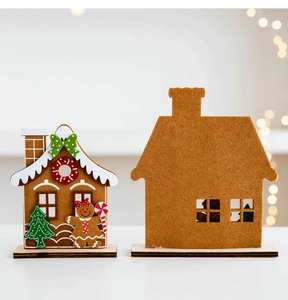 Detailed view of handmade felt gingerbread house with wooden base for Christmas table decor