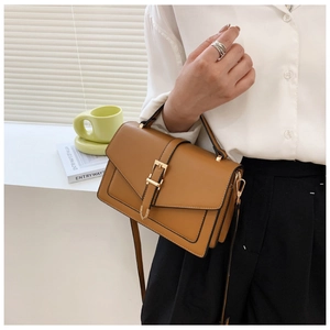 Brown PU leather crossbody bag featuring gold buckle detail and adjustable shoulder strap